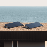 Balkonkraftwerk mit Solarmodulen auf einem Flachdach mit Blick auf das Meer